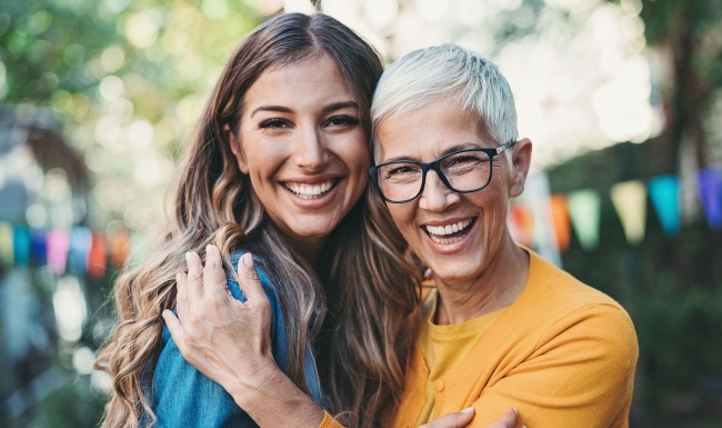 an adult child and mom embracing